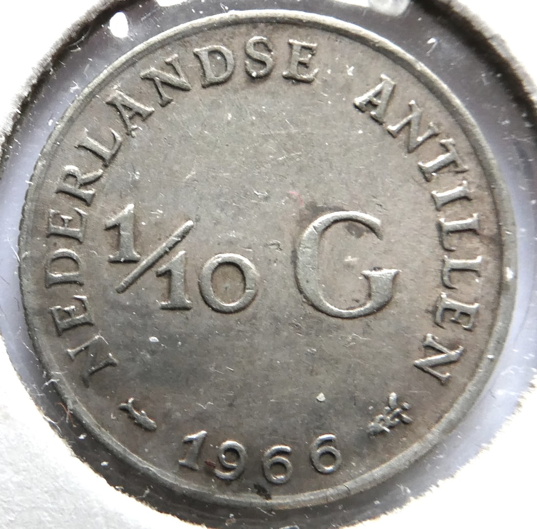 1966 Netherlands Antillien 1/10 Gulden silver coin: CountryNetherlands AntillesDenomination1/10 guldenYear1966PeriodQueen Juliana (1952 - 1980)Coin typeCirculation coinsRulerJulianaCompositionSilver 0.640Edge typeReededShapeRoundAlignmentCoin (180Â°)