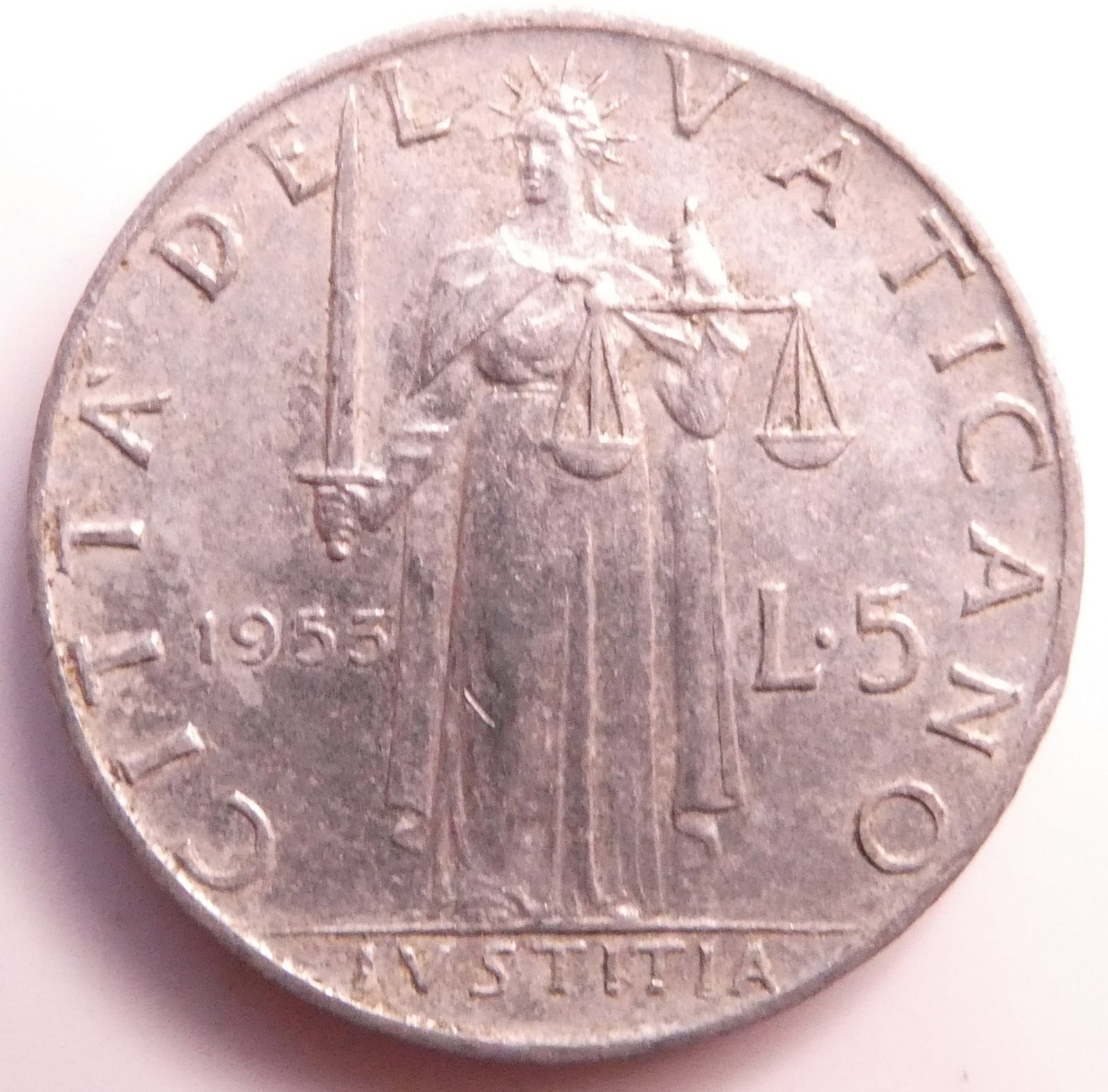 1955 Vatican City 5 Lire Coin: IssuerVatican City PopePius XII (1939-1958)TypeStandard circulation coinYears1951-1958Value5 Lire (5 VAL)CurrencyLira (1929-2001)CompositionAluminiumWeight1 gDiameter20.2 mmThickness1.6 mmShapeRoundTe