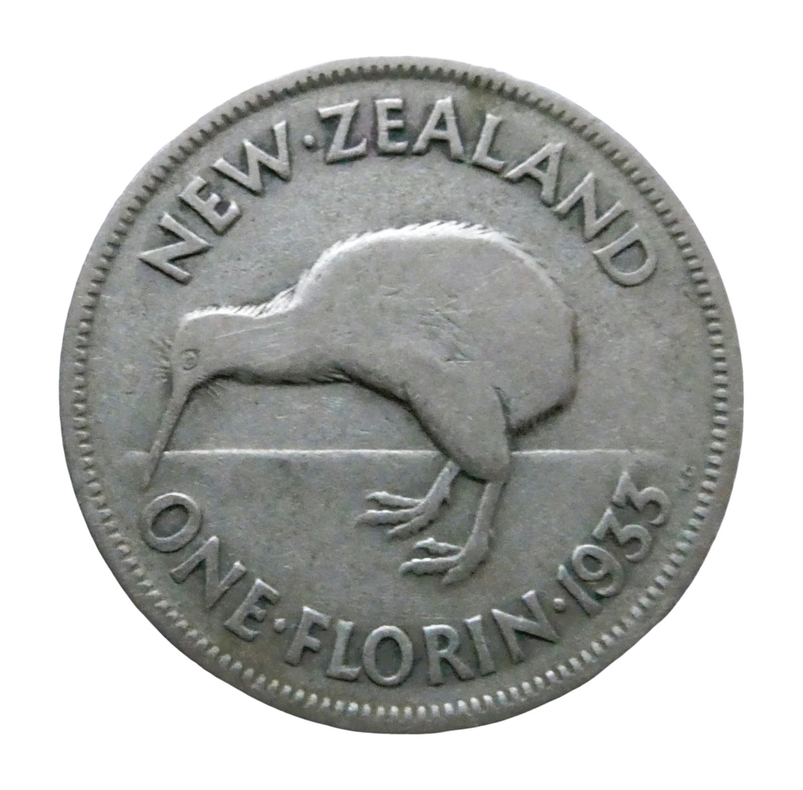 1933 New Zealand Florin, George V, Silver, One of 2.1M minted: This 1933 New Zealand florin features the left-facing crowned bust of King George V on the obverse, encircled by the legend ?GEORGE V KING EMPEROR”. The reverse depicts a detailed image of a kiw