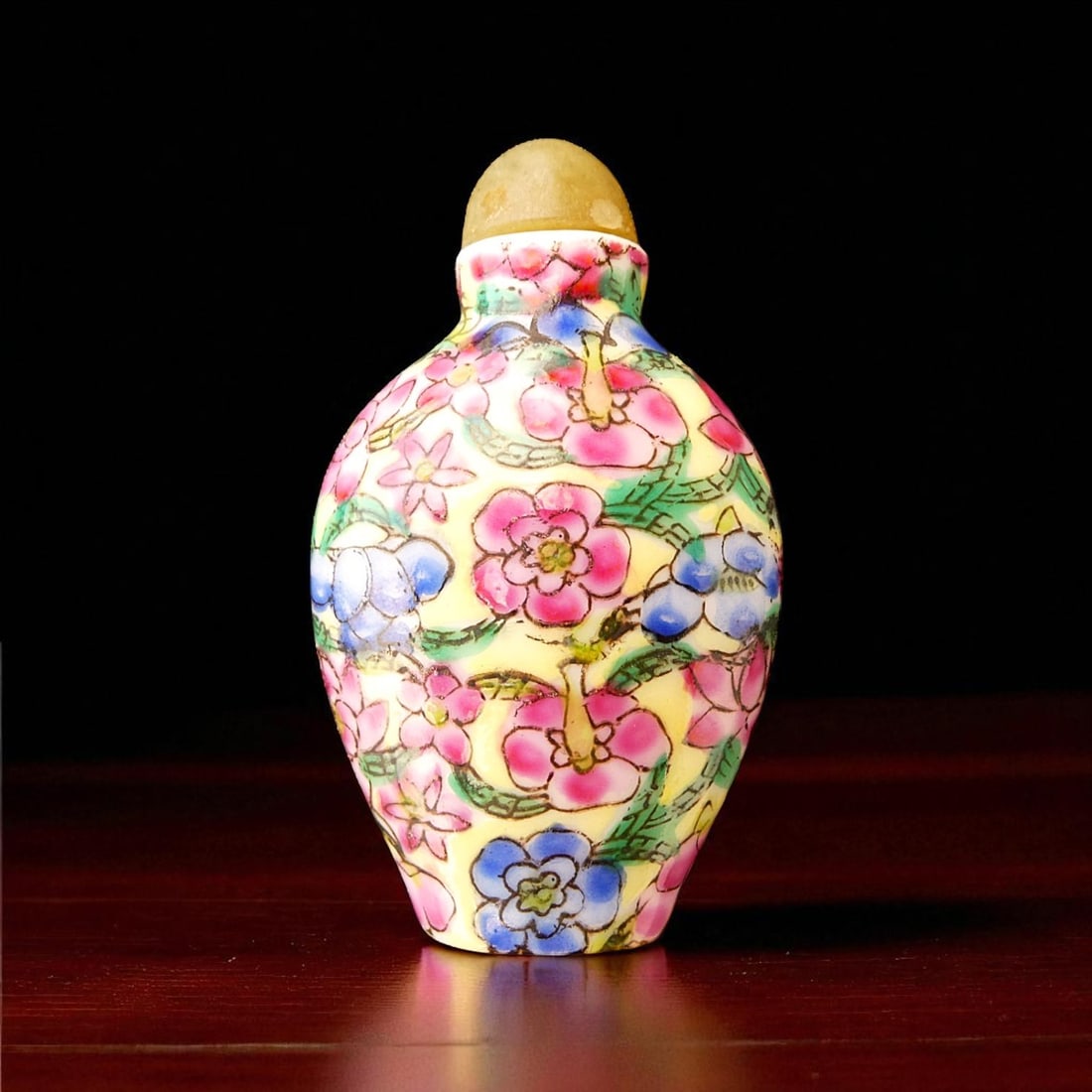 Republic Period Chinese Porcelain Snuff Bottle with Floral Millefleurs Decoration: This vividly enameled Chinese porcelain snuff bottle, dating from the Republic Period (circa 1912–1949), exemplifies the enduring decorative tradition of millefleurs—“thousand flowers”—i