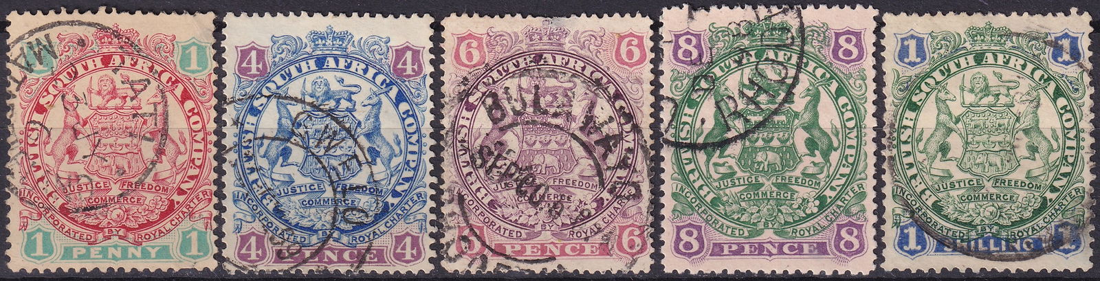 1896 British South Africa Company Coat of Arms Scott RH 27b 31 32 33 34: This original used stamp group was issued in 1896 by the British South Africa Company during the formative years of company administration in southern Africa and belongs to the celebrated Coat of Arms