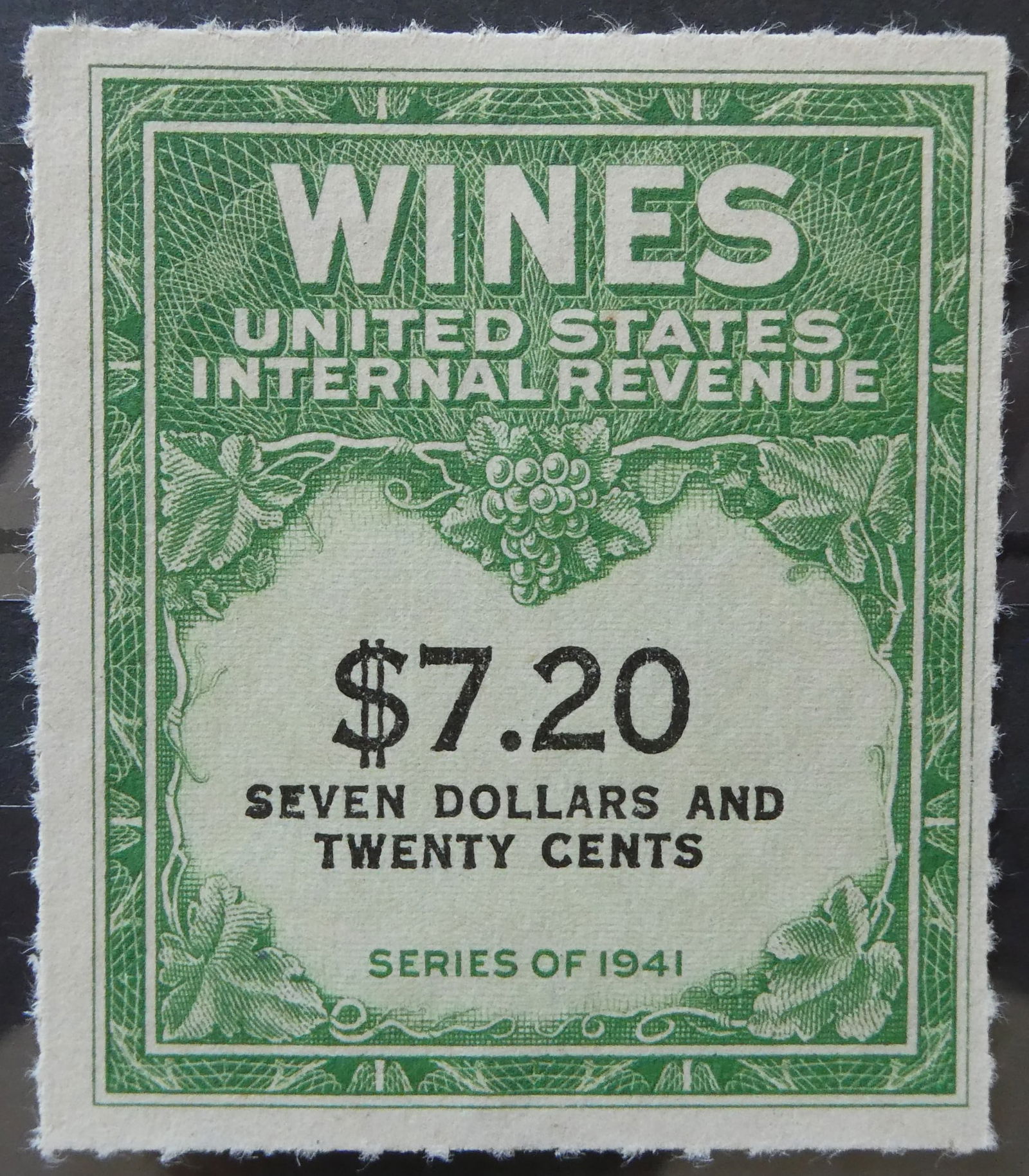 1941 US Internal Revenue Wine Stamp, $7.20 Green, Unused: This United States Internal Revenue stamp was issued as part of the 1941 "WINES" series, a federal excise tax program applied to alcohol products under the Treasury Department. Bearing a high denomina