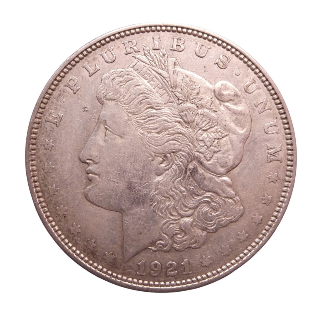 1921 United States Morgan Dollar Denver Mint Silver Coin: This 1921 Morgan Dollar is a silver circulation coin struck at the Denver Mint during the final year of production for the historic Morgan series. Designed by George T. Morgan, the obverse features th