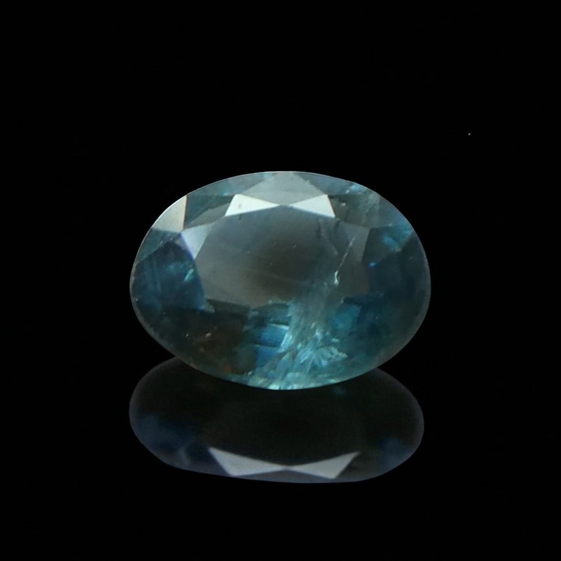 0.65 ct Greenish Blue Sapphire, Oval Mixed Cut, Heated, ALGT Certified: A refined and characterful natural sapphire weighing 0.65 carat, this gem has been expertly cut in an oval mixed style and measures 5.91 x 4.86 x 2.59 mm. The sapphire displays a distinctive greenish-