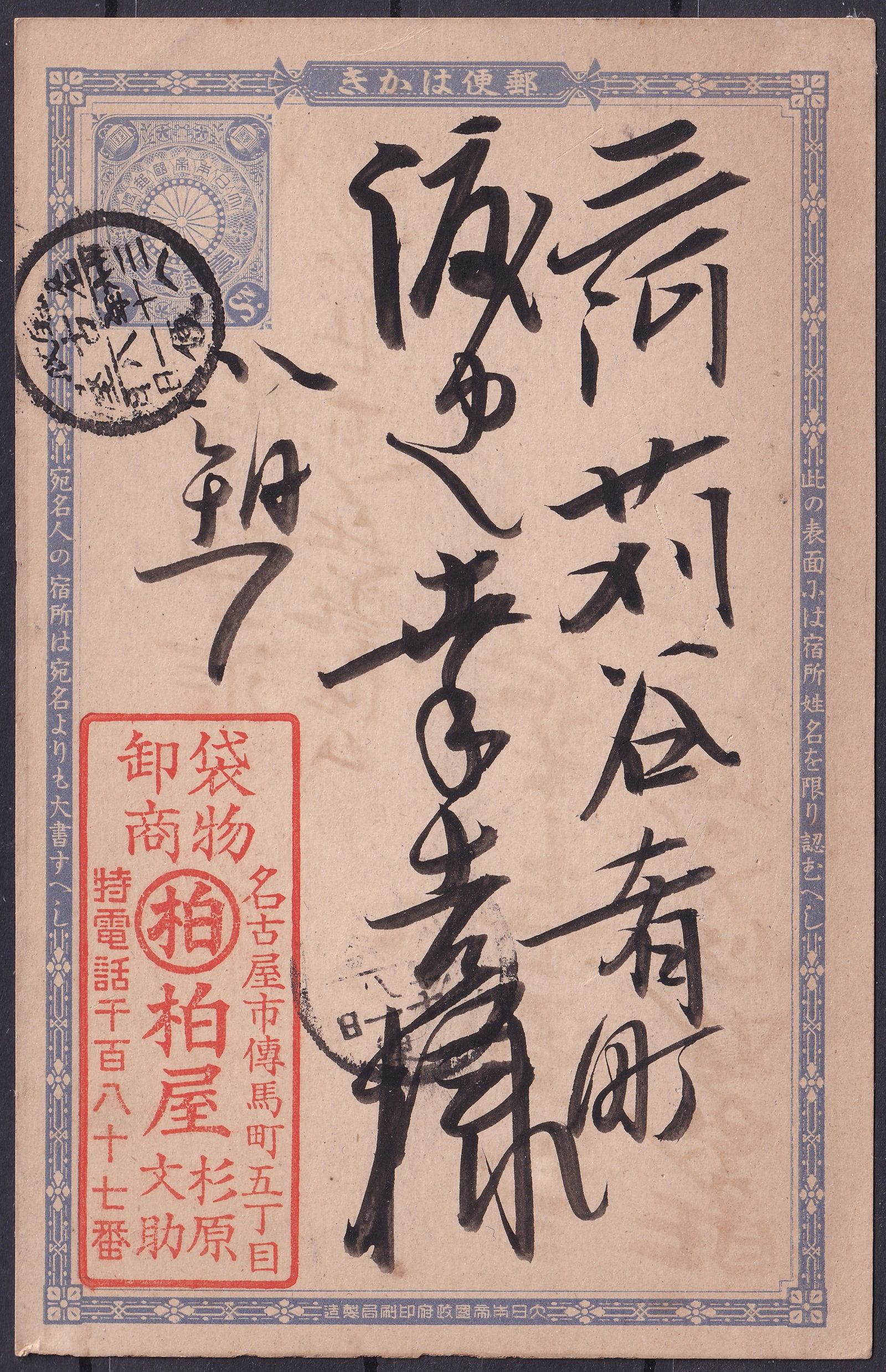 Meiji-Era Japan Postal Card with Calligraphic Address and Message, ca. 1890s: An original Japanese postal stationery card from the Meiji era, featuring a finely printed chrysanthemum crest indicium in blue at top left, denoting official postal use under Imperial authority. The