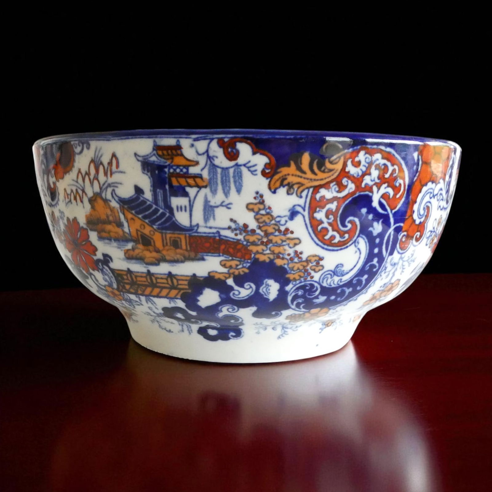 Japanese 19th Century Imari Style Porcelain Bowl with Landscape Motif: An impressive 19th century Imari style porcelain bowl, finely decorated in underglaze cobalt blue and overglaze iron red and gilt enamels. The exterior depicts a continuous landscape scene with tradit