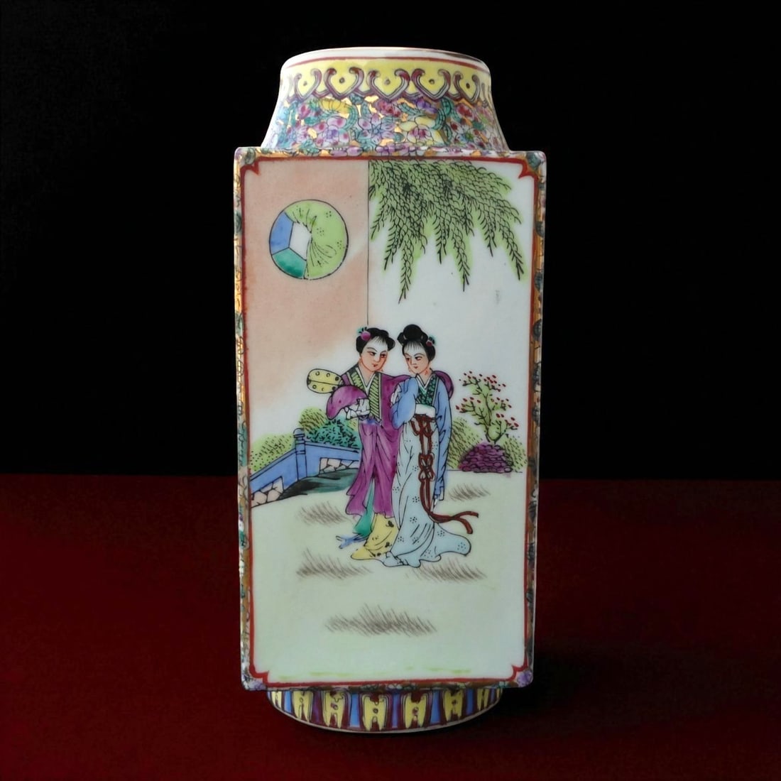 Famille Rose Jiagong Rectangular Porcelain Vase with Landscape and Court Figures, ca. 1950: This refined famille rose rectangular porcelain vase, produced in Hong Kong circa 1950, represents the enduring legacy of Qing Dynasty enamel traditions adapted for mid-20th century export and collect