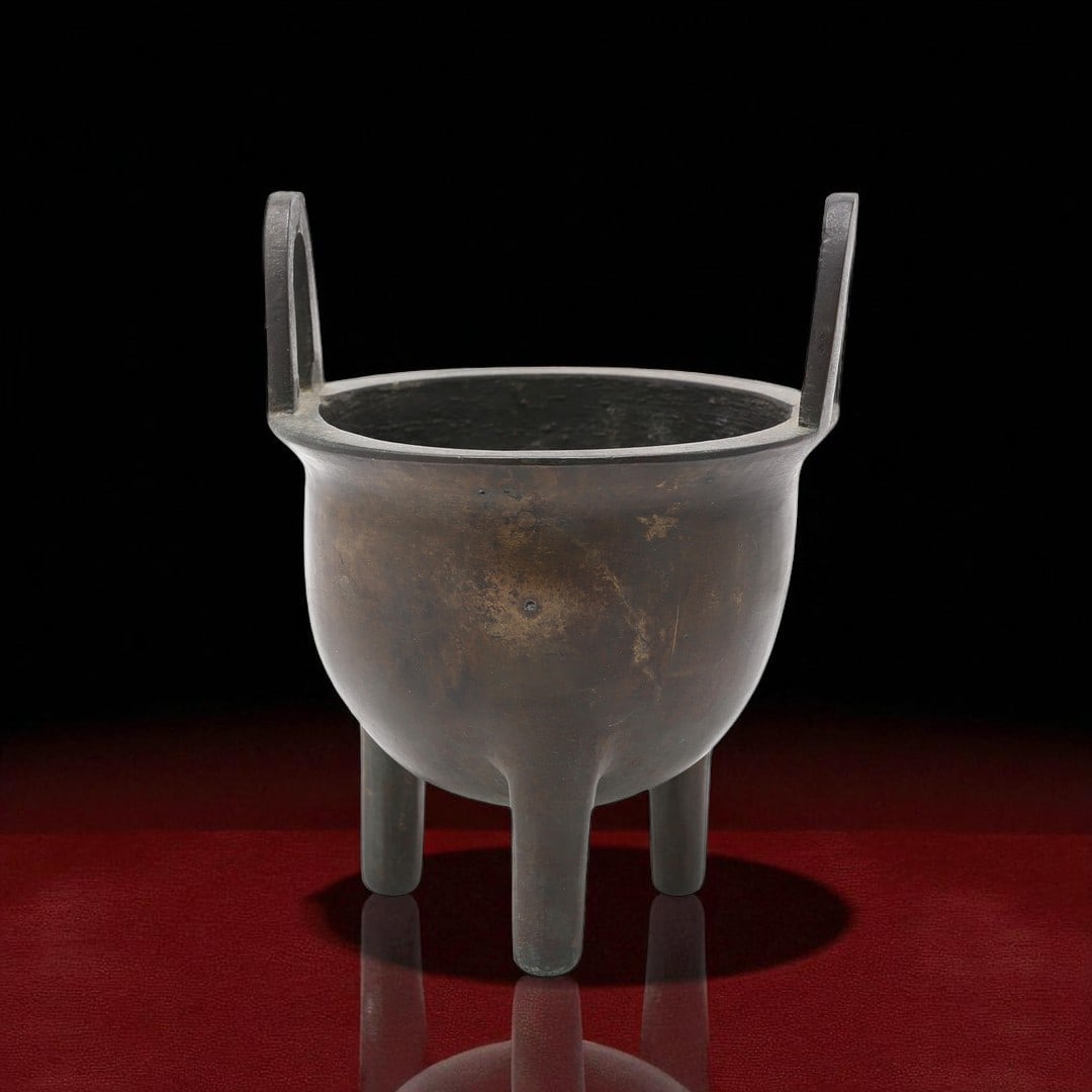 Qing Dynasty Bronze Censer with Xuande Mark: A traditional Chinese tripod censer cast in bronze, standing approximately 15 cm tall, featuring a pair of upright loop handles and three evenly spaced legs. The form is characteristic of ritual incen