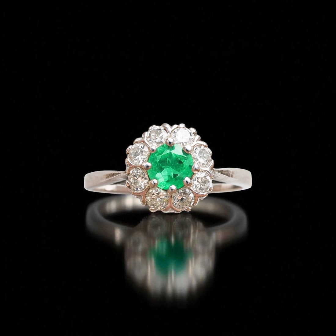 IGI Certified Emerald and Diamond Ring, 18K White Gold, 0.50 ctw: This elegant ring is crafted in solid 18 karat white gold and holds a vivid round mixed-cut emerald of natural Brazilian origin, weighing approximately 0.20 carats. The emerald exhibits a deep bluish