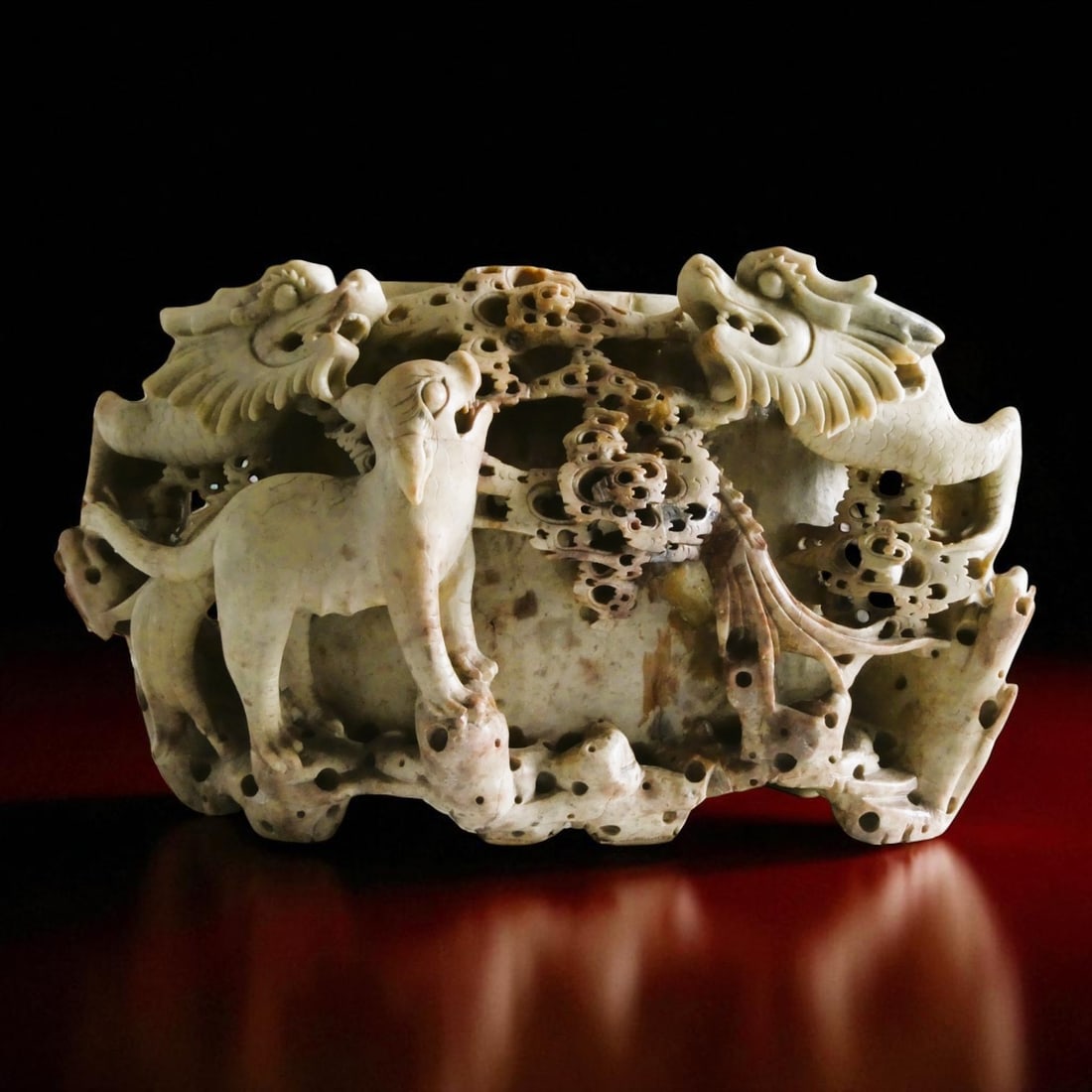 Large Chinese Soapstone Brush Pot, Qing Dynasty, 1800s: A monumental Chinese brush pot carved from a single block of soapstone, dating from the Qing Dynasty, circa 1800?1900. The pot is masterfully worked in deep relief with two prominent sinuous dragons (