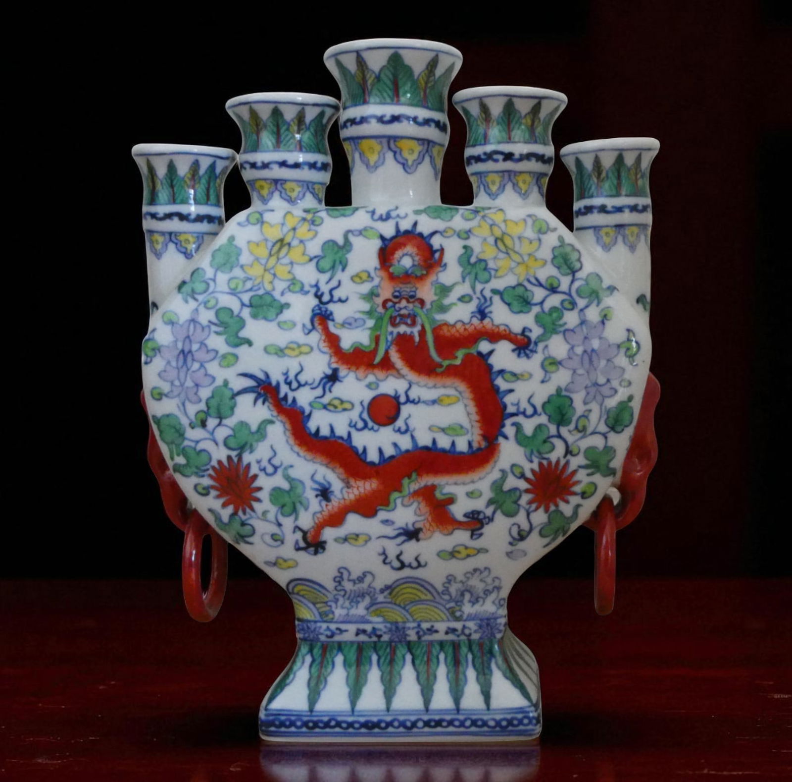 Chinese Famille Verte Dragon tulip Vase with Qianlong Mark, 20th Century: This polychrome enameled porcelain vase features a striking five-spout design with a flattened body and is decorated in vibrant famille verte palette. The central motif on both sides is a dynamic red