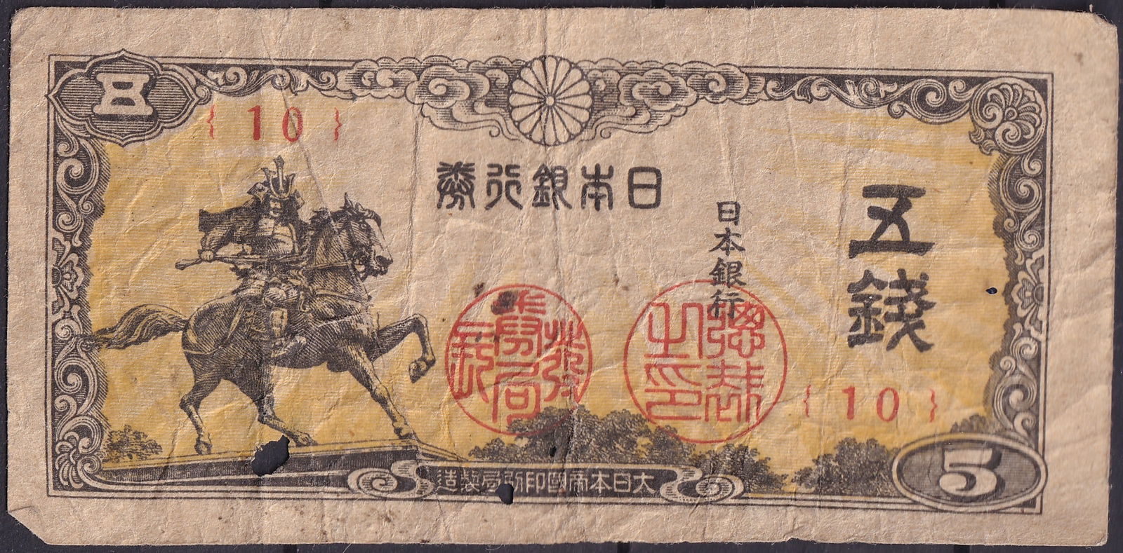 Japan 5 Sen 1938 Samurai on Horseback, Showa 13 Bank of Japan Issue: Issued in 1938 (Showa year 13), this 5 Sen note (Pick 63) from the Bank of Japan features an evocative engraving of a samurai warrior on horseback, capturing the martial valor and spirit of Japan’s