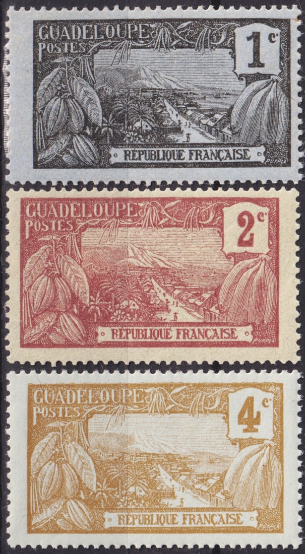 French Guadeloupe 1905 Landscape Issue 1c–4c Scott #54–56 MH Trio: Issued in July 1905, the Guadeloupe “Landscape” series represents one of the most visually compelling definitive sets of the early 20th century French colonial period. The design features a pa