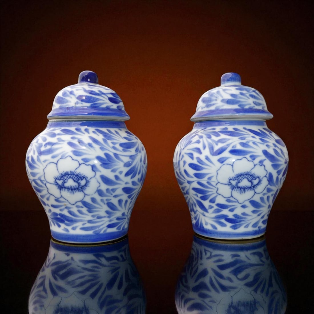 Pair of Chinese Blue and White Covered Jars, Late Qing, c.1900: A refined pair of small Chinese blue and white porcelain lidded jars, dating to the late Qing Dynasty, circa 1900. Each vessel stands 11 cm tall with a maximum width of 7.5 cm, and weighs 257 g and 25