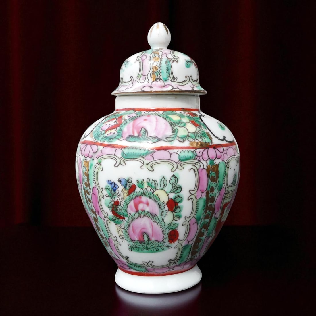 Mid-20th Century Macau Famille Rose Covered Jar with Peony Motif: This elegant porcelain covered jar originates from Macau and dates to the 1950s, exemplifying the refined artistry of the mid-20th century famille rose tradition. Measuring 15.5 cm in height and 10 cm