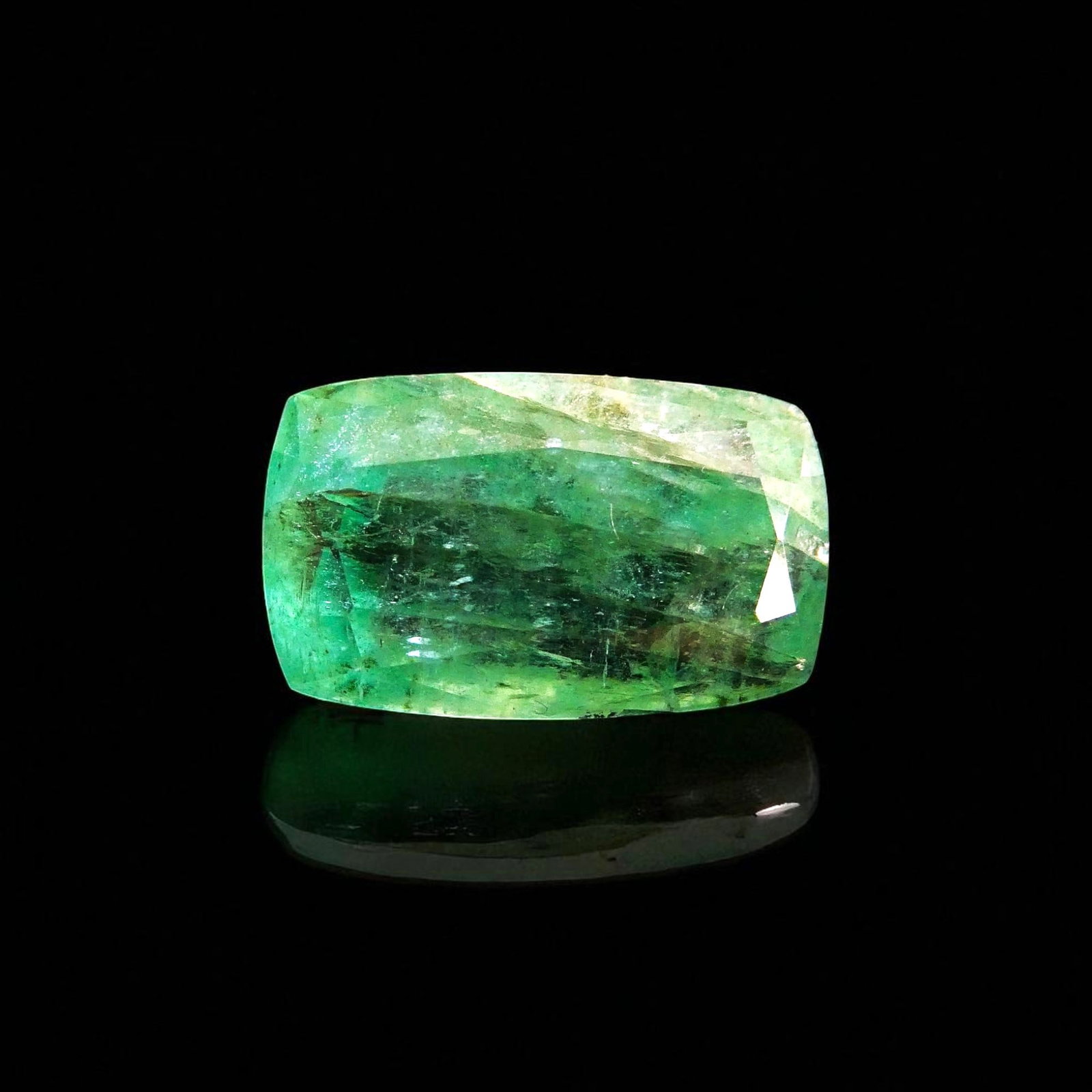 9.98 ct Cushion-Cut Emerald, Light Green, Swat Valley Pakistan, IGI: This impressive natural emerald originates from the famed Swat Valley in Pakistan, a region celebrated for producing emeralds of exceptional beauty and character since the mid-20th century. The gemsto
