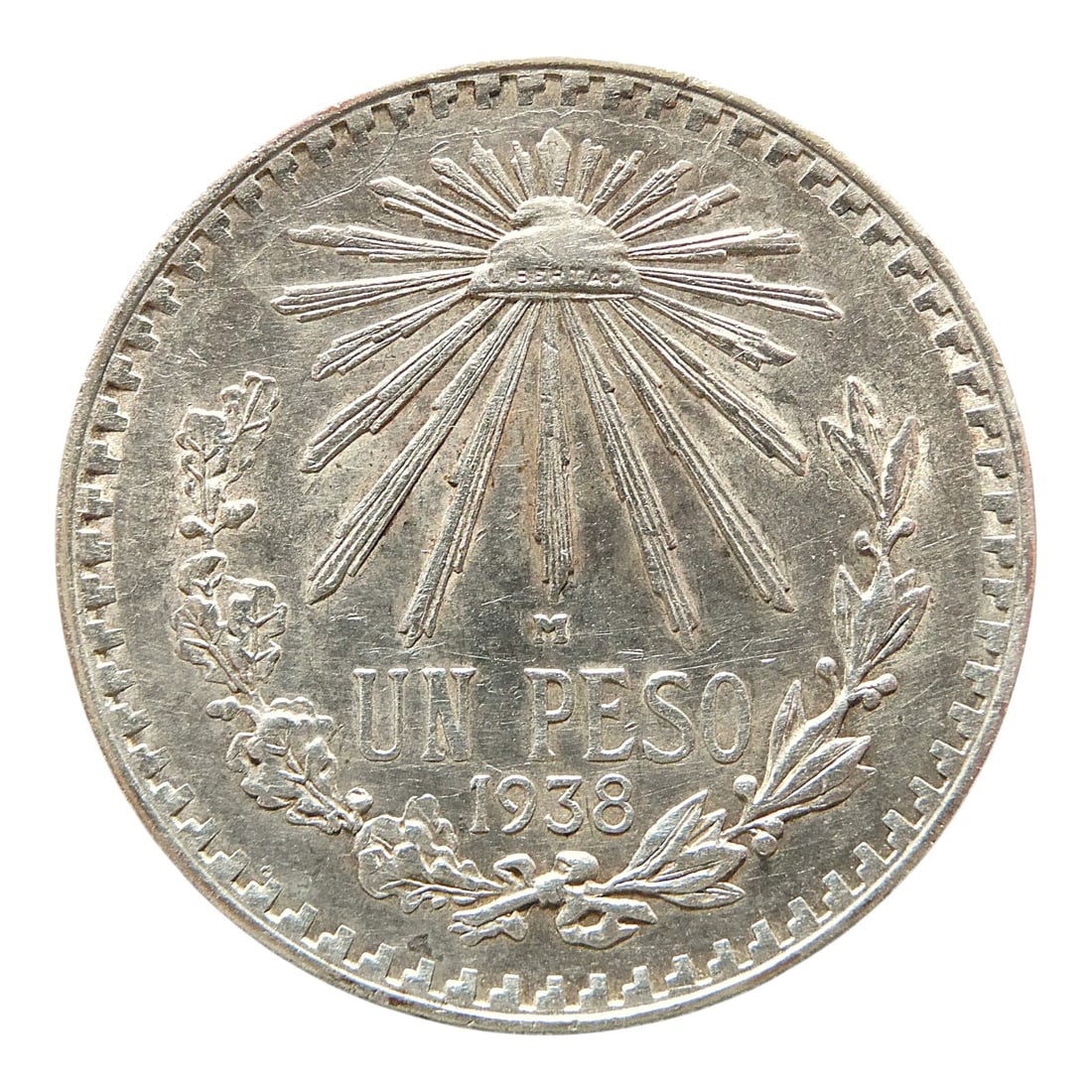 Mexico Silver Peso 1938 United Mexican States, Eagle, Liberty Cap: This silver one peso coin was minted in Mexico in 1938 under the authority of the United Mexican States during a period of national reform and cultural consolidation. Struck in .720 silver with a weig