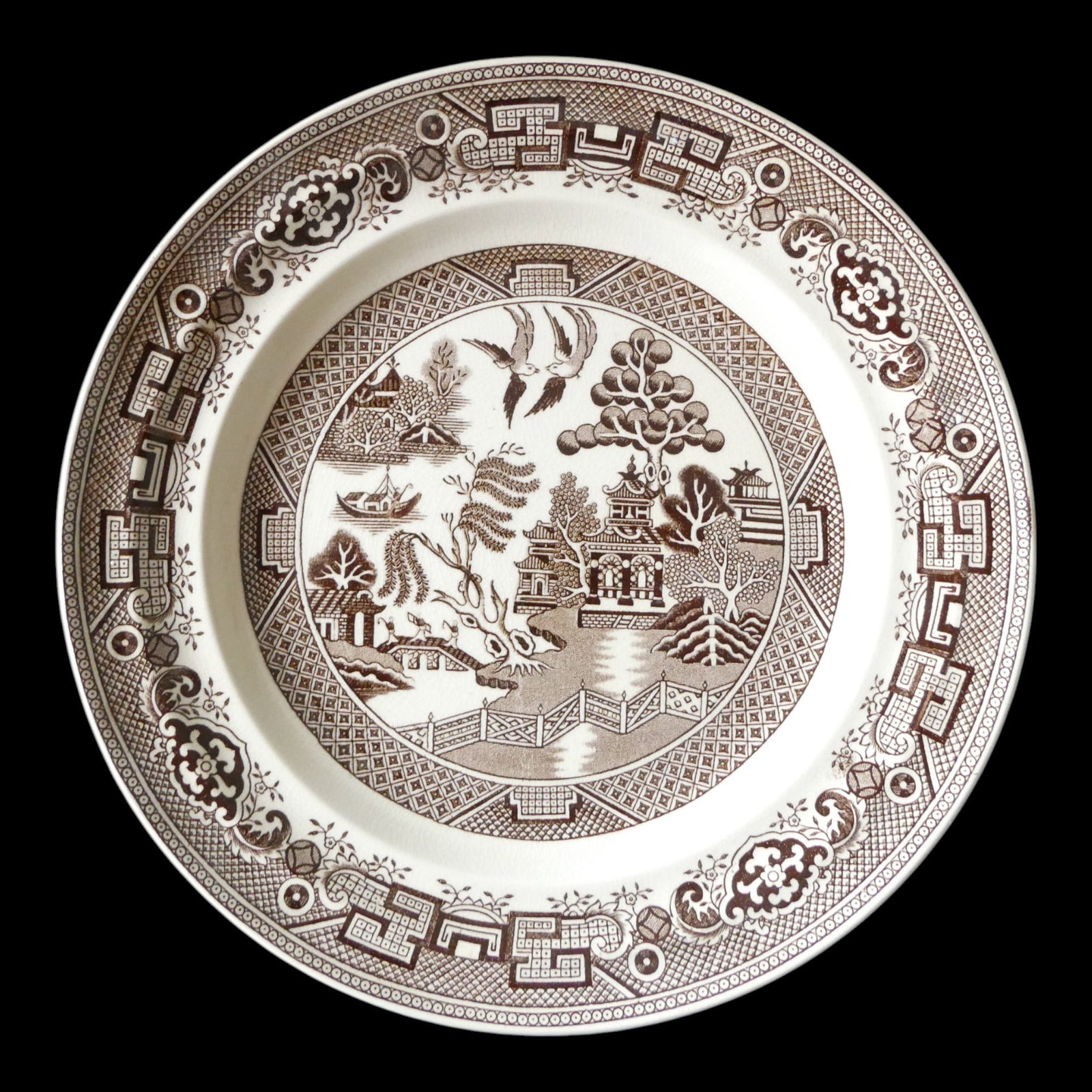 Gustafsberg Willow Plate, China-Inspired Swedish Faience, 19th Century: This elegant faience plate was produced by Gustafsberg in Sweden and features the timeless “Willow” pattern, rendered in rich brown transfer print. Measuring 25 cm in diameter and weighing 466