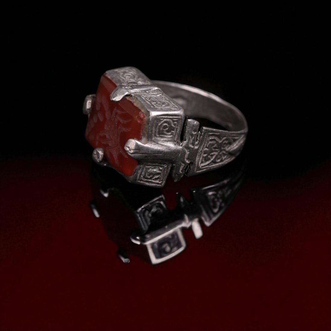 Ottoman Empire Intaglio Ring, Silver-Metal with Scorpion Seal, ca 18th-19th Century: An impressive silver-metal ring from the Ottoman Empire the inner diameter is 19mm, featuring a bold rectangular bezel set with a finely carved red hardstone intaglio. The intaglio depicts a detailed 
