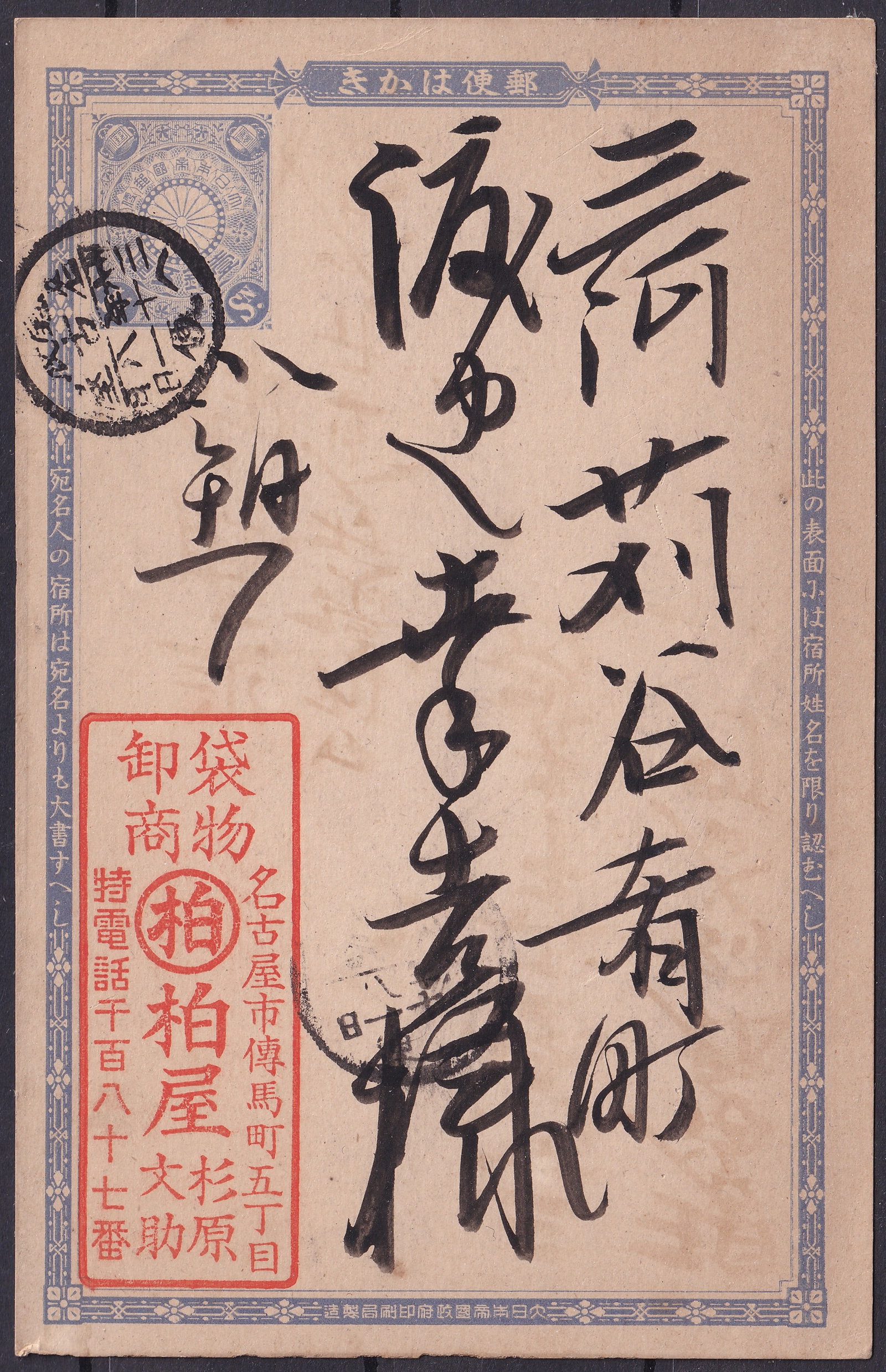 Meiji-Era Japan Postal Card with Calligraphic Address and Message, ca. 1890s: An original Japanese postal stationery card from the Meiji era, featuring a finely printed chrysanthemum crest indicium in blue at top left, denoting official postal use under Imperial authority. The 