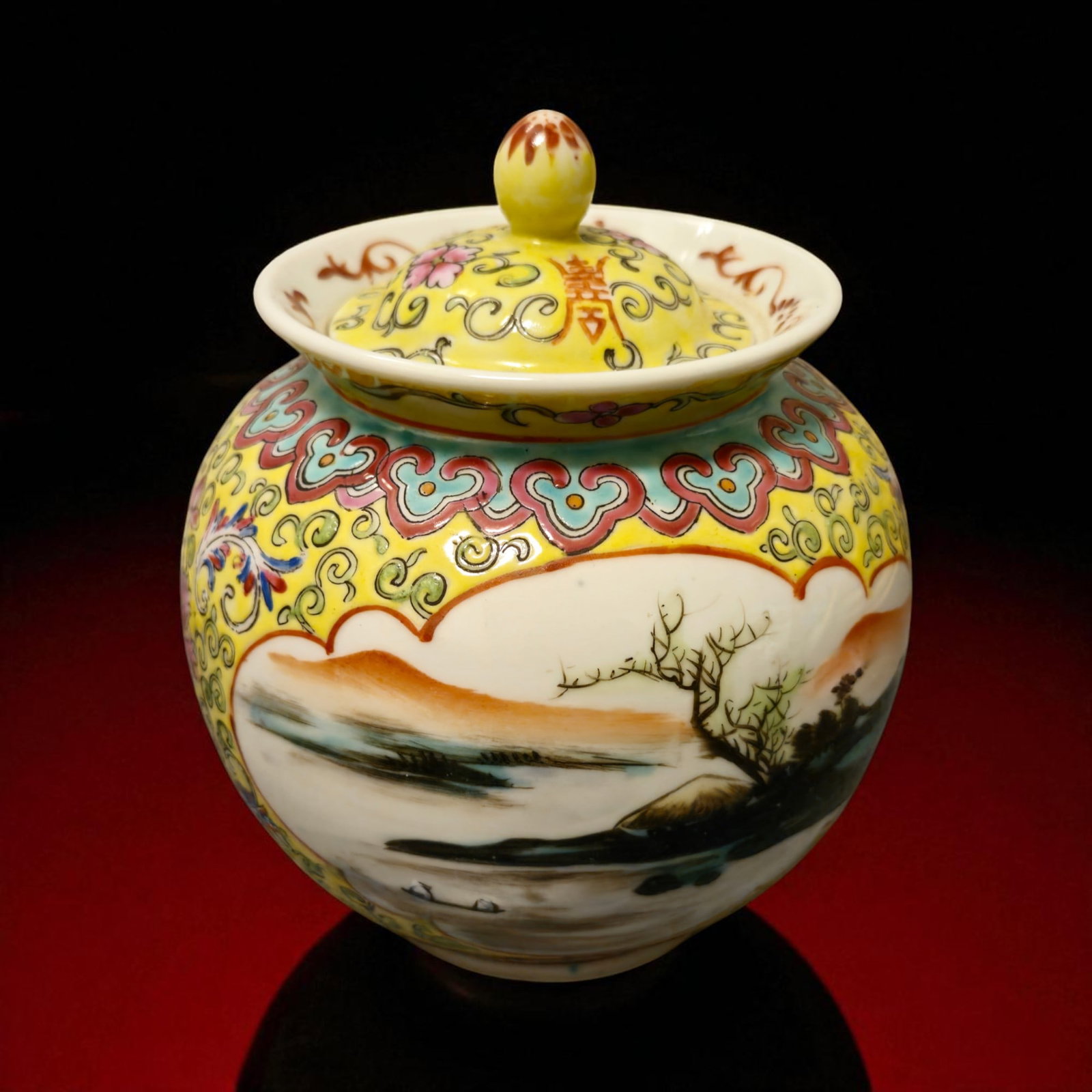 Chinese Famille Rose Covered Jar, Republic Period, 20th Century: A finely enamelled porcelain covered jar, decorated in the famille rose palette with vibrant floral and landscape motifs. Standing 14.5 cm high and 8.8 cm wide, with a total weight of 451 grams, the j