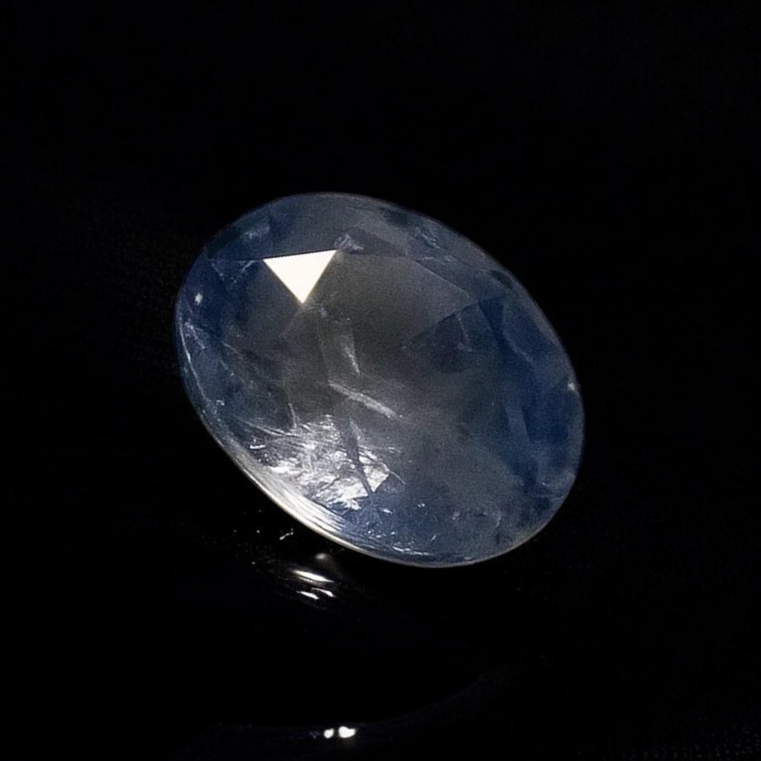Sapphire Natural Corundum Oval Mixed Cut 0.68 Carat ALGT3117907: This fine natural corundum sapphire weighing 0.68 carat presents an oval mixed cut measuring 5.76 x 4.91 x 2.88 mm and displays a blue to colorless uneven hue with transparent clarity according to ALG