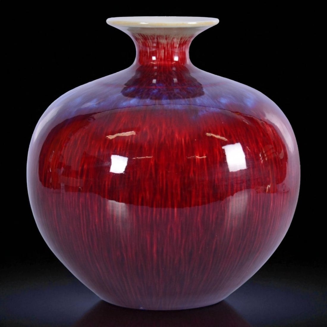 Early 20th Century Chinese Oxblood Flambe Glazed Vase, Signed, 27 cm: This striking porcelain vase from early 20th century China stands 27 cm tall and is finished in a flamboyant oxblood glaze, known as "sang de boeuf" or "Langyao hong" (???). The vivid red glaze cascad