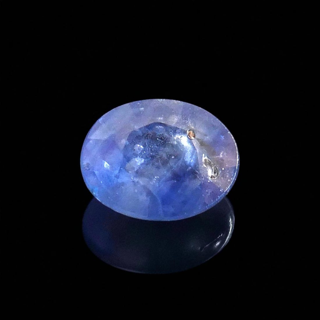 0.80ct Natural Blue Sapphire, Oval Mixed Cut – ALGT Certified: An ALGT-certified natural sapphire weighing 0.80 carats, presented in an elegant oval mixed cut that showcases both brilliance and depth. This gemstone, measuring 5.87 × 4.61 × 3.03 mm, belongs to t