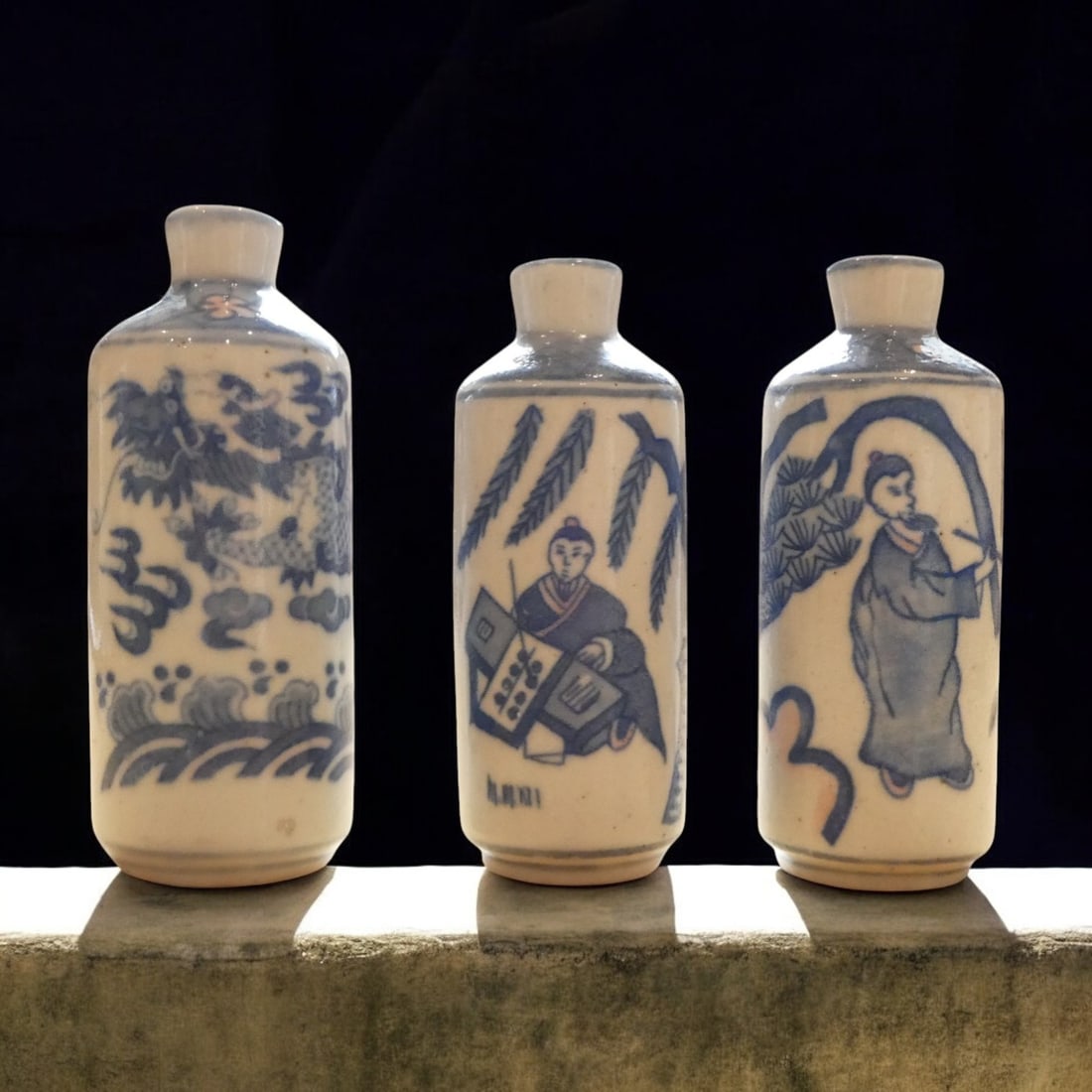 Group of Three Large Blue and White Porcelain Snuff Bottles, Late Qing Dynasty, 19th Century: An impressive trio of large blue and white porcelain snuff bottles, measuring between 9 and 10 cm in height, dating to the late Qing dynasty, 19th century. Cylindrical in form with gently tapering sho