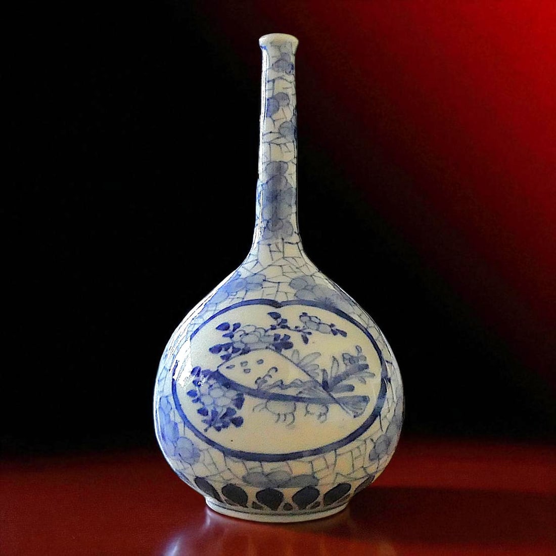 European Blue and White Porcelain Bottle Vase in Chinoiserie Style, c. 1850: This refined blue and white porcelain bottle vase, produced circa 1850, reflects the European fascination with chinoiserie design during the 19th century. Standing 23.5 cm tall, with a body diameter o