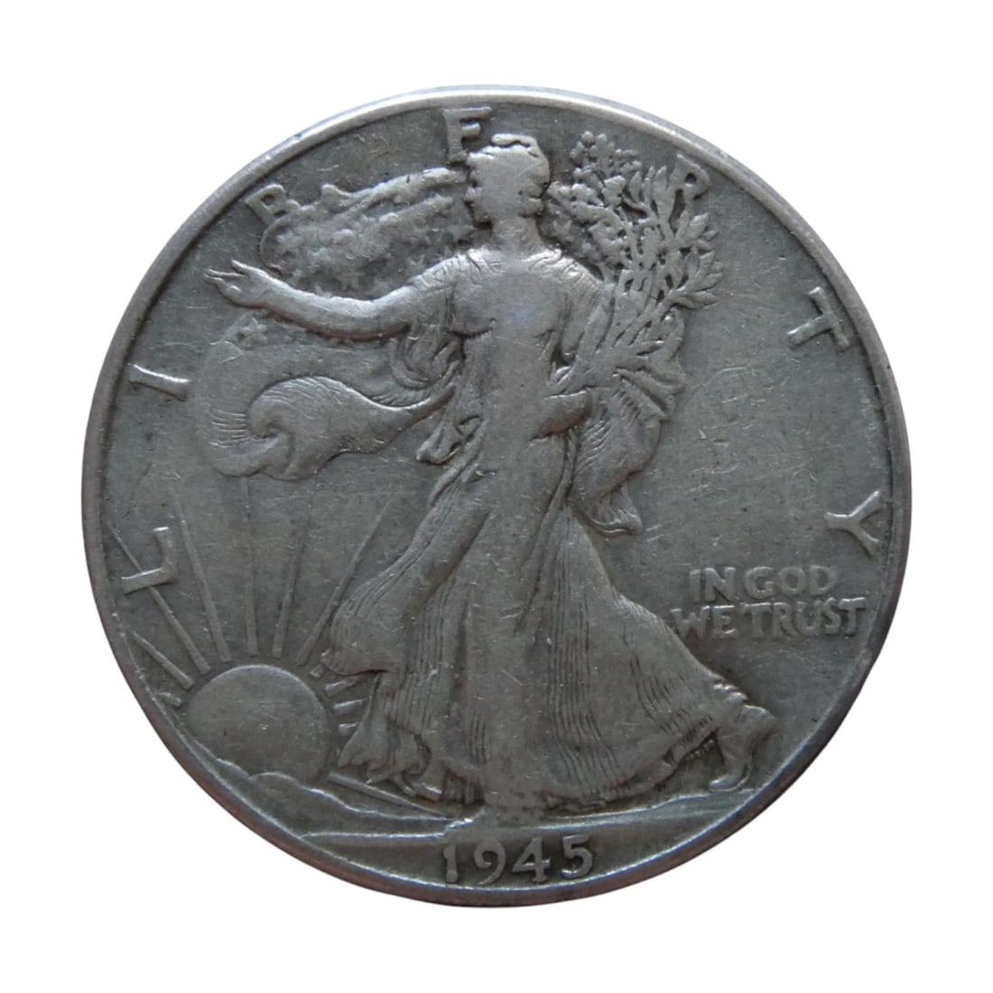 1945 U.S. Walking Liberty Half Dollar, Silver .900, Circulated: This 1945 Walking Liberty Half Dollar is a classic example of mid-20th-century American coinage, struck in 90% silver with a weight of 12.5 grams. Designed by Adolph A. Weinman and minted from 1916 to