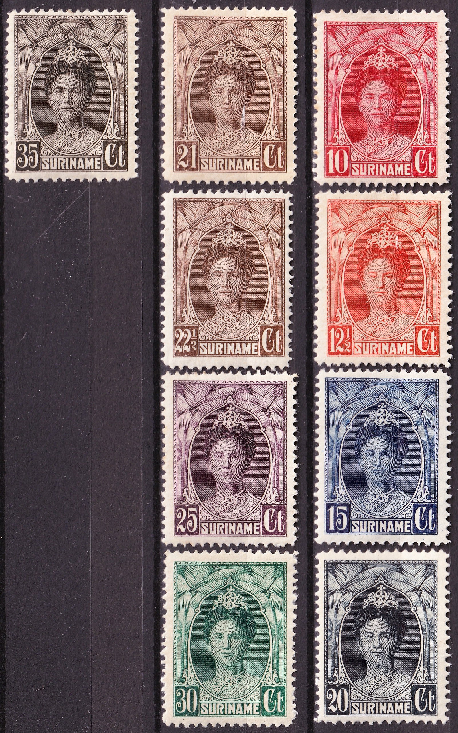 1927 Suriname Queen Wilhelmina Complete 9-Stamp Set, Michel 124-132, Scott 123-131: Issued on April 30, 1927, this complete nine-stamp definitive set from Suriname features Queen Wilhelmina of the Netherlands in the revised jubilee portrait type, framed by an ornate colonial design w
