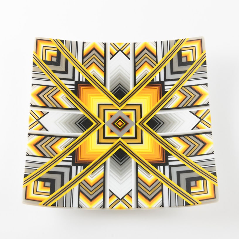 Ian Chadwick 'Yellow/gray symmetrical composition': Precision becomes hypnotic in Ian Chadwick's Yellow/Gray Symmetrical Composition. Constructed from deconstructed striped stringer sheets, this kiln-formed vessel radiates outward in an intricate