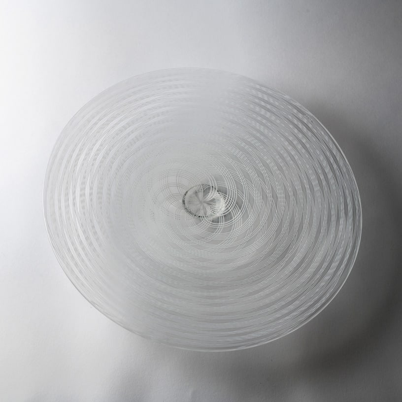 Adam Holtzinger 'Cane Platter': Sometimes virtuosity whispers. Adam Holtzinger's Cane Platter is almost entirely clear, yet fine white lines spiral concentrically through the broad form, gathering into a mesmerizing vortex at its