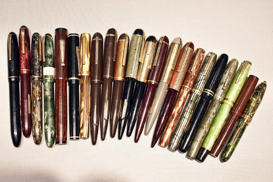 22 Lever-Fill Fountain Pens with Gold Nibs: A grouping of 22 lever-fill fountain pens in various styles and by various makers, all with marked 14K nib. Lot to include: Venus; Waterson; Jefferson; Waltham; Eversharp; Majestic; The Moore Pen Co.,
