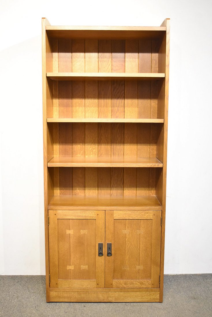 Stickley Oak Bookcase: A contemporary Stickley/E.J. Audi Arts & Crafts tall oak bookcase with four adjustable shelves over a two-door base. 80 in tall x 34 in wide x 12 in deep.