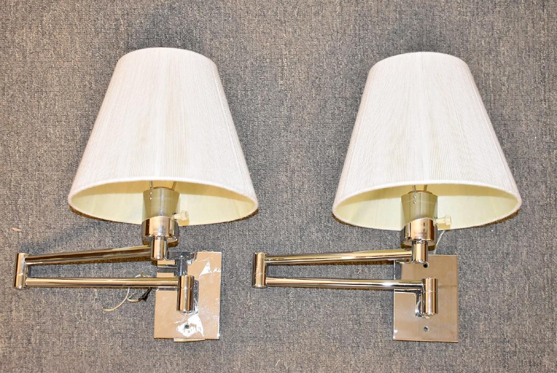 Pair of Hansen Swing-Arm Wall Lamps: A pair of Hansen swing-arm wall lamp sconces with a polished chrome finish and beige cotton string shades. 14in tall. Shades: 9in diameter.