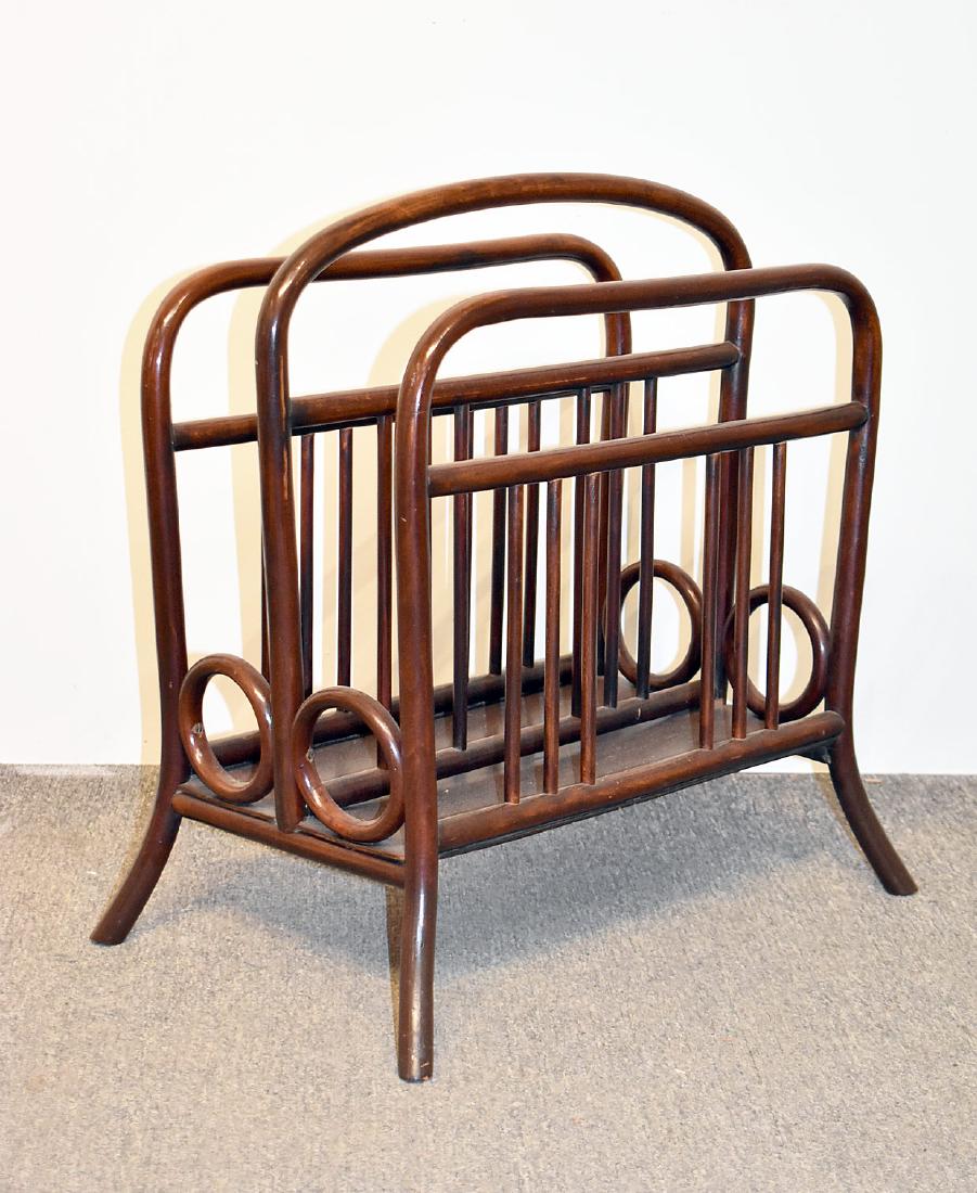 Thonet Newspaper/Magazine Rack: A Thonet bentwood with dark stain newspaper/magazine rack, circa 1910, Austria, with paper label on base. 20in tall x 20-1/2in wide x 14in deep.