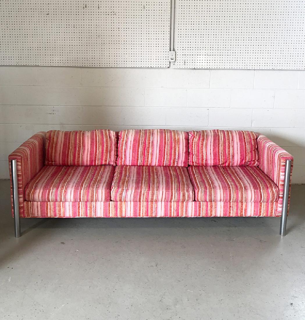Selig Chrome Modernist Sofa: A Selig Monroe modernist sofa with pink striped upholstery and chrome tubular legs. 25in tall x 85-1/2in long x 35in deep.