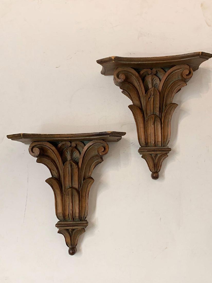 Pair of Carved Softwood Wall Brackets: A pair of carved leaf-form wall brackets with traces of old green paint. 14-3/4in tall x 13-1/2in wide x 6-3/4in deep.