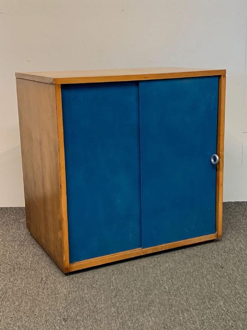 Paul McCobb Planner Group Cabinet: A Paul McCobb Planner Group birch cabinet with blue painted sliding doors, ring pull, and shelf interior. 25in tall x 24in wide x 18in deep.