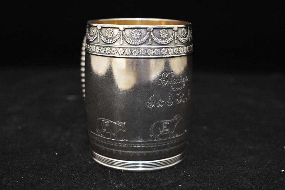 American 19th C. Silver Child's Mug: An American 19th C. sterling silver child's nursery rhyme mug with a parcel gilt interior, sterling marks for Gorham Mfg. Co, production date letter K - 1878. With engraving. 3-5/8in tall.