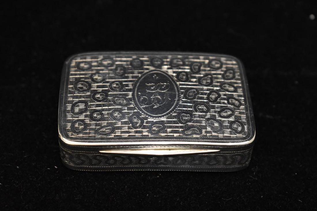 George III Silver Snuff Box: A George III silver snuff box, Birmingham, 1804, Joseph Taylor. Curved rectangular form with bright-cut engraving, basket weave bottom, and parcel gilt interior. Engraved monogram "TT". 2-11/16in long
