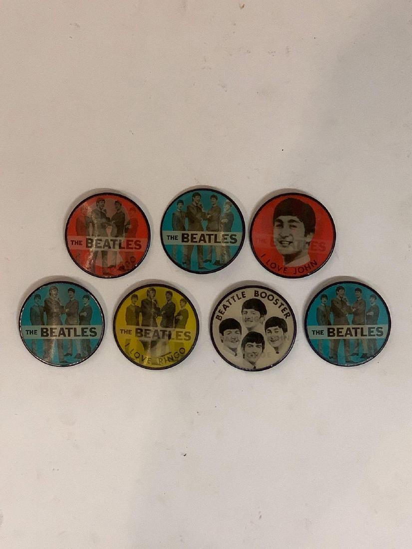 Group of Seven Beatles Vintage Flasher Buttons: A grouping of seven vintage Beatles flasher buttons. Vari-Vue, Mt. Vernon, NY. 2-1/2 in diameter.
