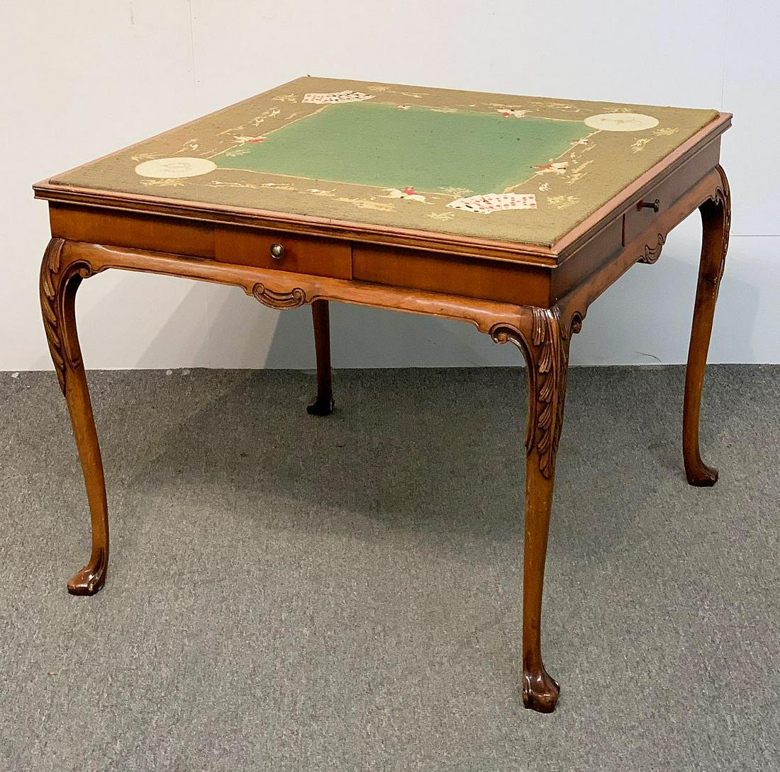 Ardley Hall Needlepoint-top Game Table: An Ardley Hall Chippendale-style carved mahogany game table with fox hunt themed needlepoint top and four drawers. 31 in tall x 37 in wide x 37 in deep.