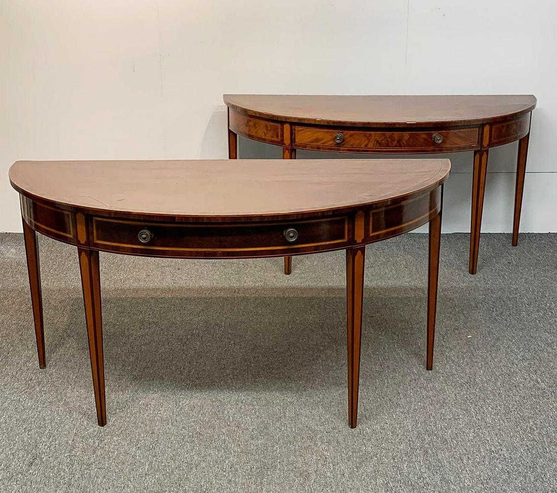 Pair of Federal Mahogany Inlaid Console Tables: A pair of federal satinwood inlaid mahogany demilune console tables, frieze fitted with single drawers and raised on four tapering legs. 29-1/2 in tall x 59 in wide x 23-1/2 in deep.