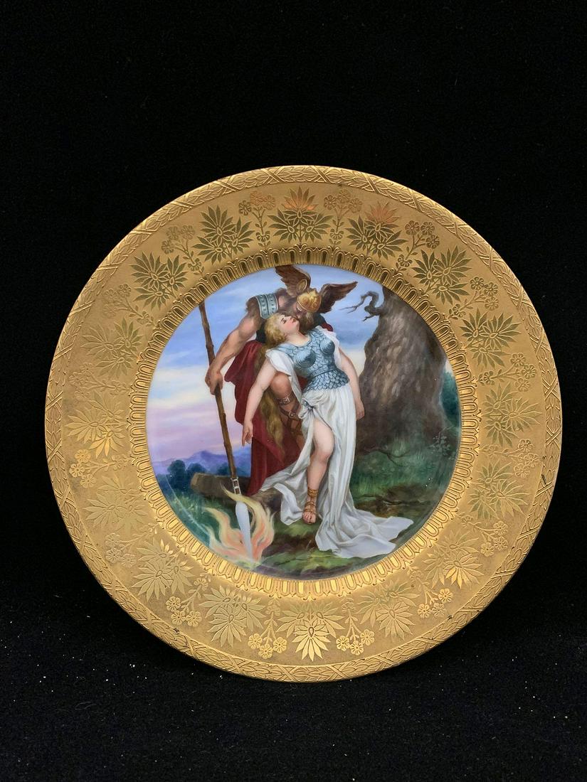 German Porcelain Cabinet Plate: A German Porcelain cabinet plate depicting Wotan and Brunhilde with gilt foliate rim. Marked on back. W. T. & v. R. Phila retailer mark. 9-1/2 in diameter.