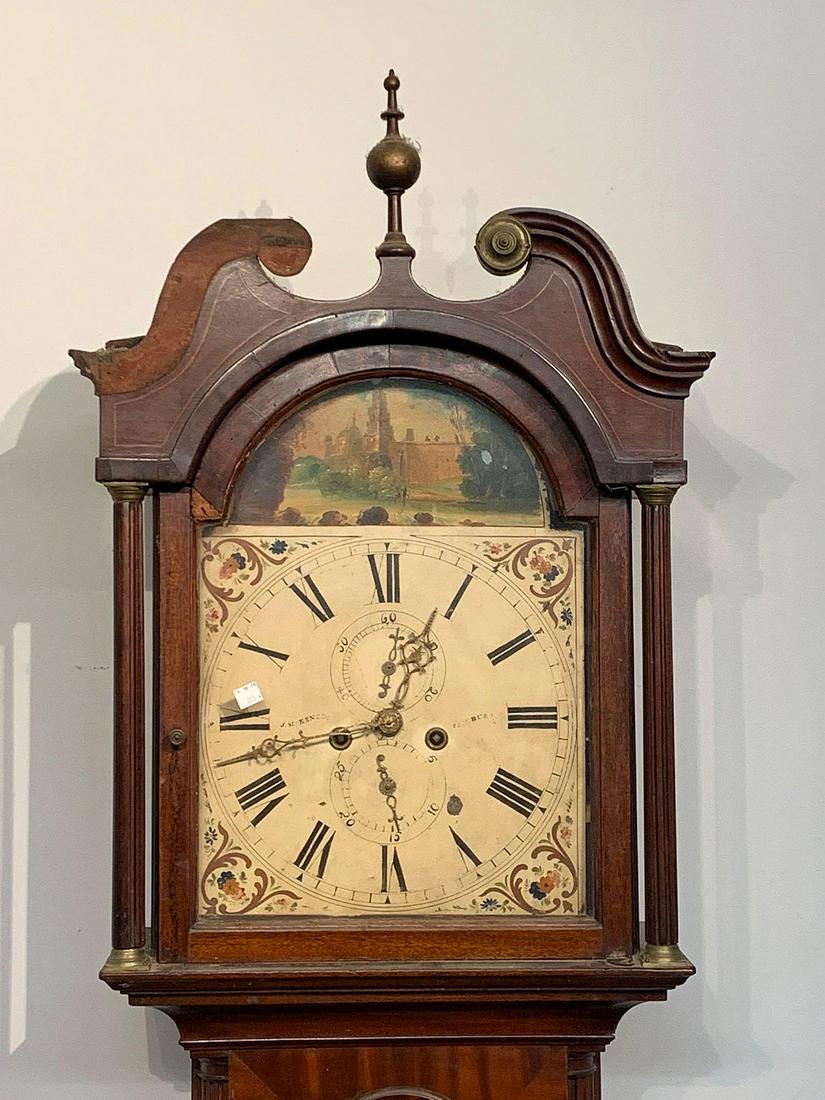 Scottish George III Tall Case Clock: A Scottish George III tall case clock with inlaid mahogany case and hand-painted steel dial marked for J. McKenzin, Edinburgh. Two weight driven. With pendulum. 87-1/2 in tall x 19 in wide x 9 in deep