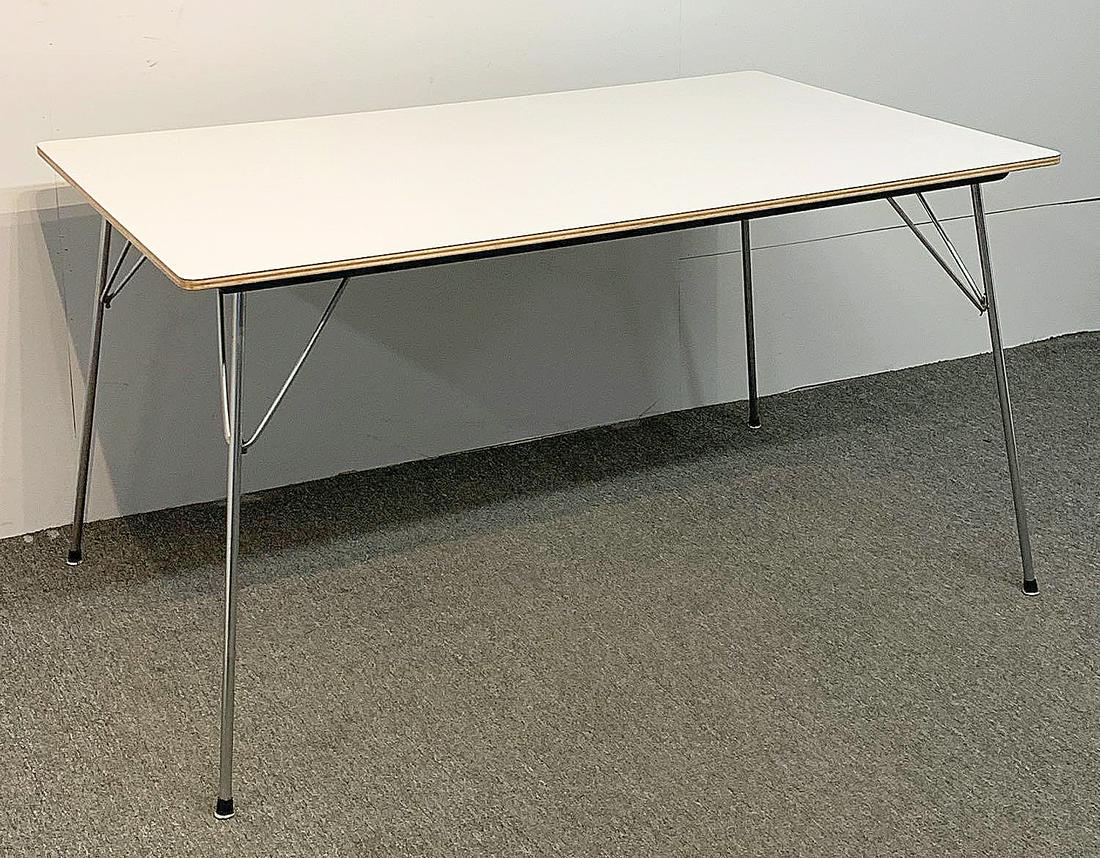 Charles & Ray Eames DTM-10 Table: Charles & Ray Eames for Herman Miller DTM-10 dining table with a plywood and white micarta top over four folding metal legs. Legs are held against table with canvas straps when folded. Marked "DTM 10"