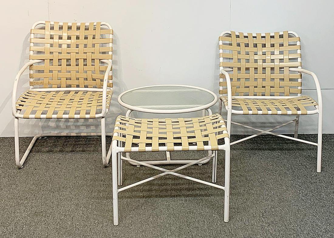 Brown Jordan Four-piece Patio Set: A vintage Brown Jordan four-piece patio set to include two chairs, ottoman, and circular glass side table. Chairs: 29 in tall x 21 in wide x 26 in deep. Provenance: The Adelman Estate Collection, Hock